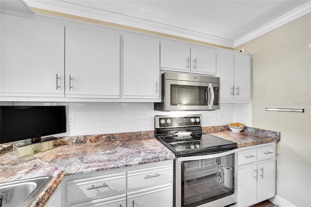 kitchen with white cabinetry, stainless steel appliances, decorative backsplash, sink, and ornamental molding