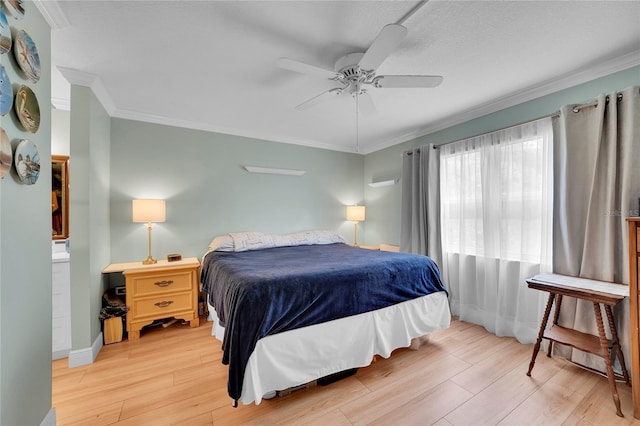 bedroom featuring ceiling fan, hardwood / wood-style flooring, and crown molding