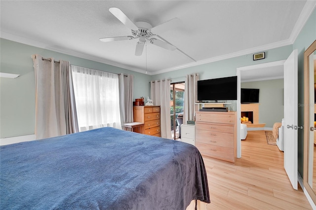 bedroom featuring ceiling fan, light hardwood / wood-style flooring, and crown molding