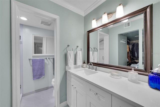 bathroom with tile patterned floors, toilet, vanity, and crown molding