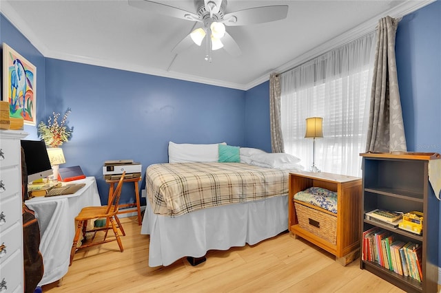 bedroom with ceiling fan, crown molding, and light wood-type flooring