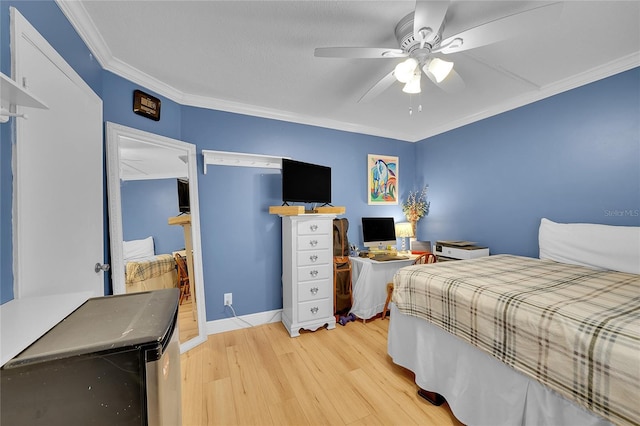 bedroom with ornamental molding, ceiling fan, and light hardwood / wood-style flooring