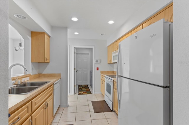 kitchen featuring white appliances, light brown cabinetry, sink, and light tile patterned floors