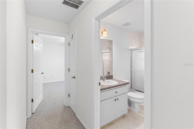 full bathroom featuring toilet, vanity, and bath / shower combo with glass door