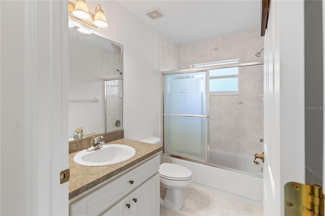 full bathroom featuring vanity, tile patterned flooring, enclosed tub / shower combo, and toilet