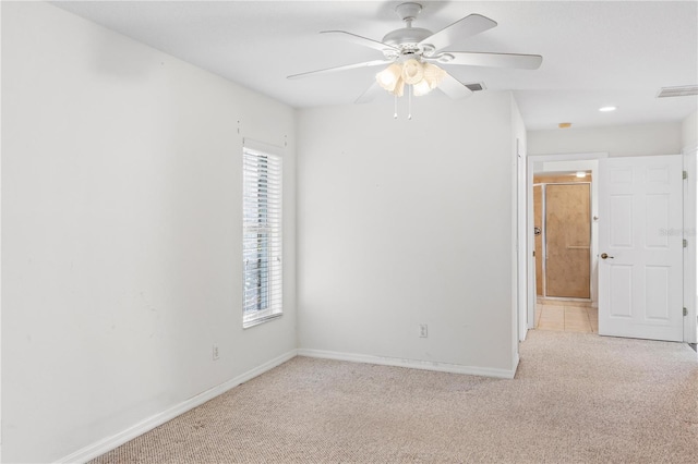 carpeted spare room with ceiling fan