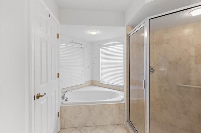 bathroom with tile patterned flooring and separate shower and tub