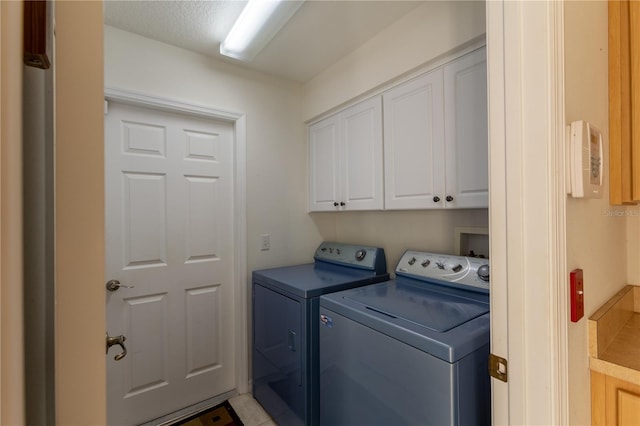 laundry area with cabinets and separate washer and dryer