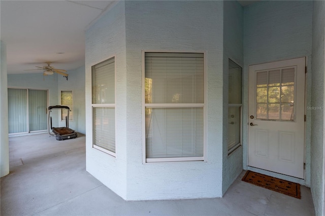 property entrance featuring ceiling fan