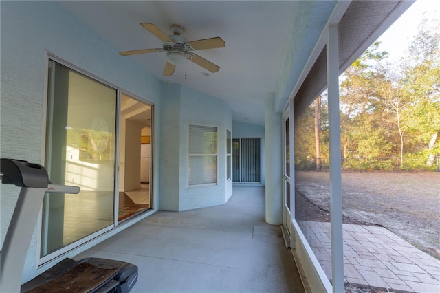 unfurnished sunroom with lofted ceiling, a wealth of natural light, and ceiling fan