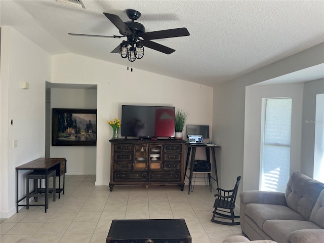 tiled living room with lofted ceiling, a textured ceiling, and ceiling fan