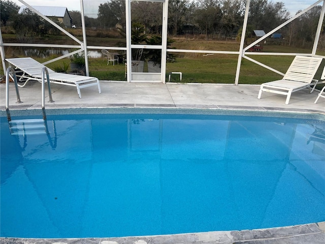 view of swimming pool featuring a lawn and a patio area