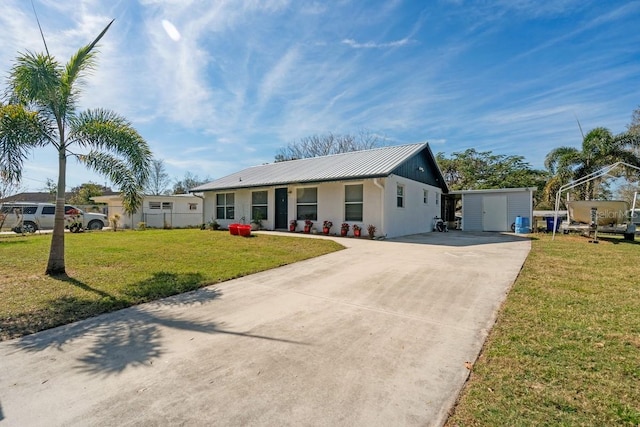 view of front of home featuring a front yard and a storage unit