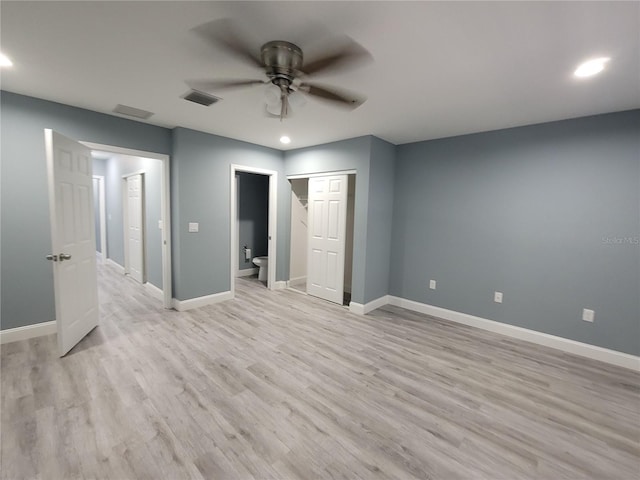 unfurnished bedroom with light wood-type flooring, connected bathroom, and ceiling fan