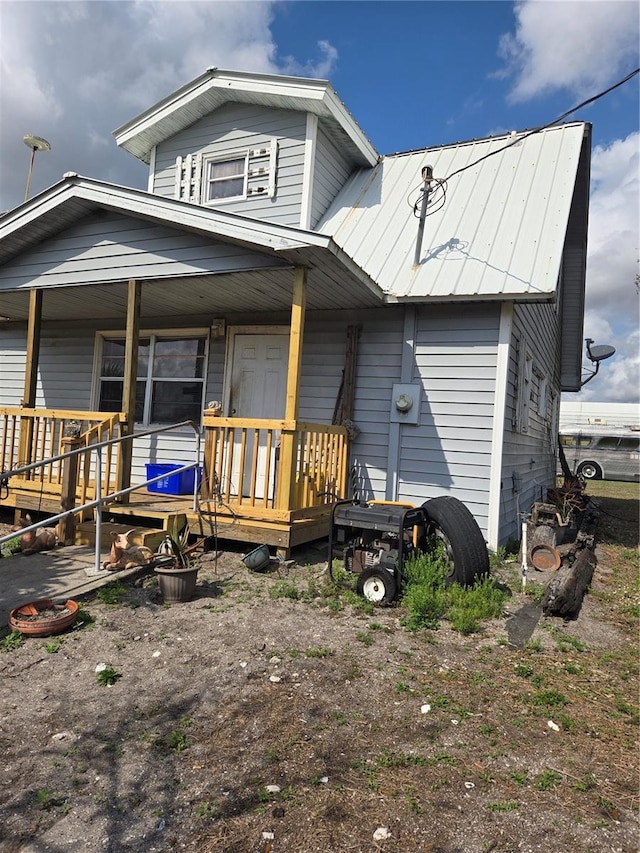 back of house featuring a porch