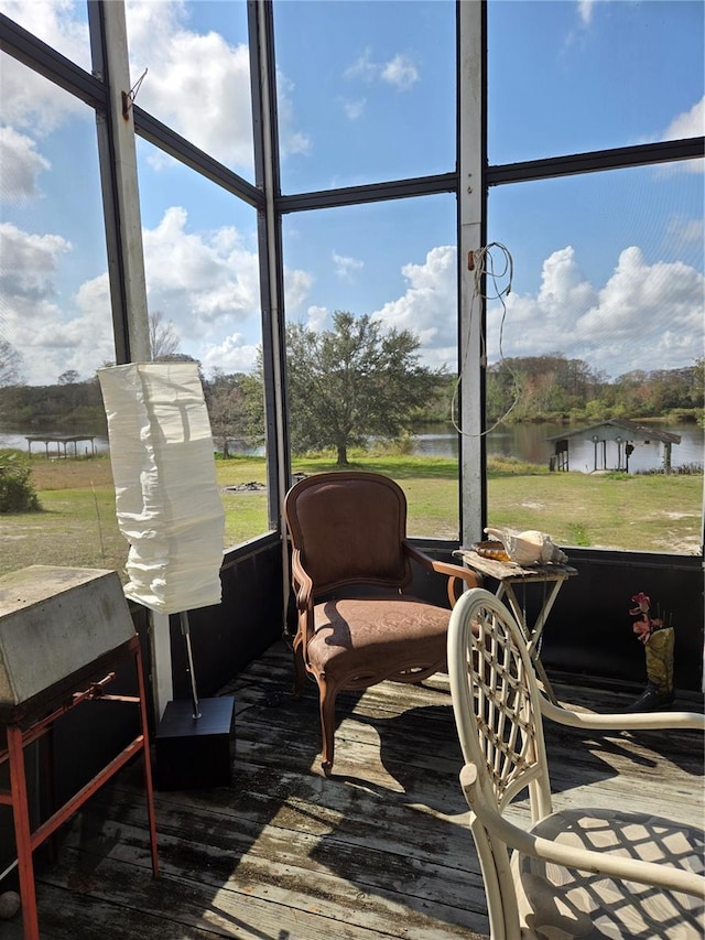 sunroom / solarium featuring a water view