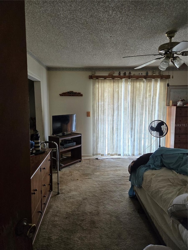 carpeted bedroom with ceiling fan and a textured ceiling