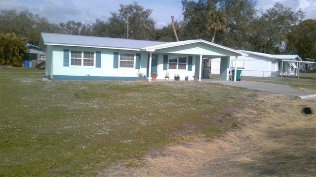 ranch-style house featuring a carport and a front lawn