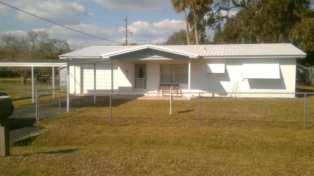 rear view of property featuring a yard