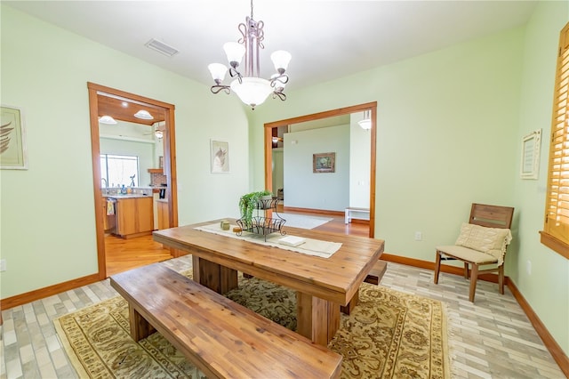 199 S Bear Pointe Dr, Lake Placid, FL 33852 - dining area featuring a notable chandelier and light hardwood / wood-style floors