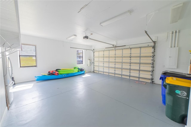 199 S Bear Pointe Dr, Lake Placid, FL 33852 - garage featuring white refrigerator, a garage door opener, and electric panel