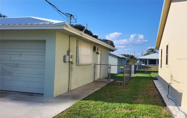 view of property exterior with a garage and a yard