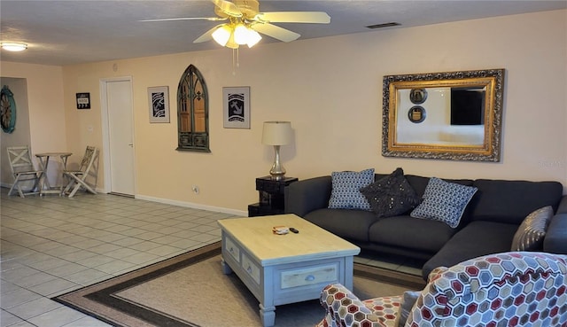 living room featuring light tile patterned floors, a textured ceiling, and ceiling fan