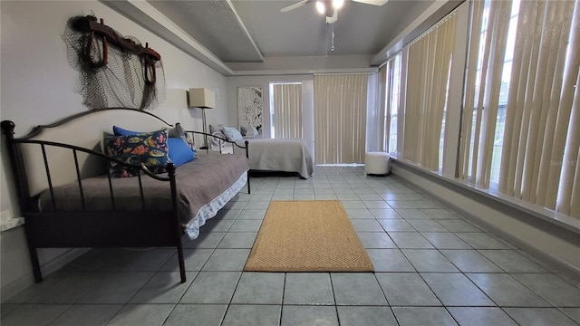 tiled bedroom with ceiling fan