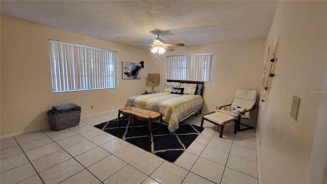 tiled bedroom featuring a textured ceiling and ceiling fan