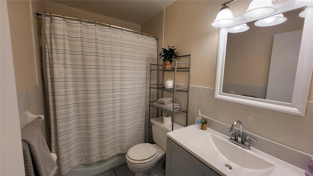 full bathroom featuring tile walls, vanity, toilet, and shower / tub combo with curtain