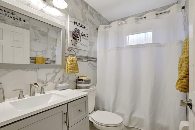 full bathroom featuring toilet, backsplash, vanity, and tile walls