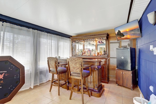 bar featuring light tile patterned flooring and a bar