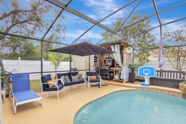 view of swimming pool with glass enclosure, fence, outdoor lounge area, and a fenced in pool