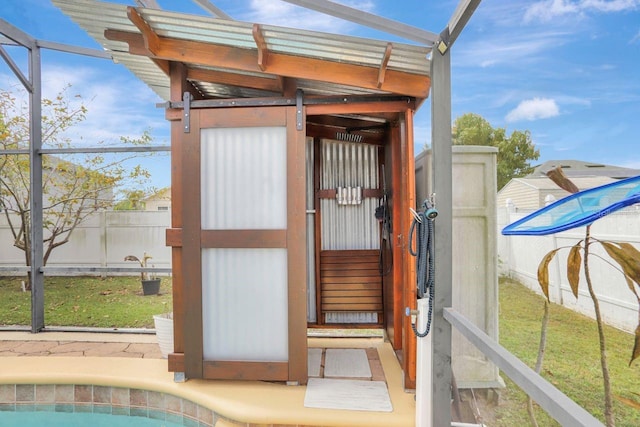 view of outdoor structure with fence and an outdoor pool