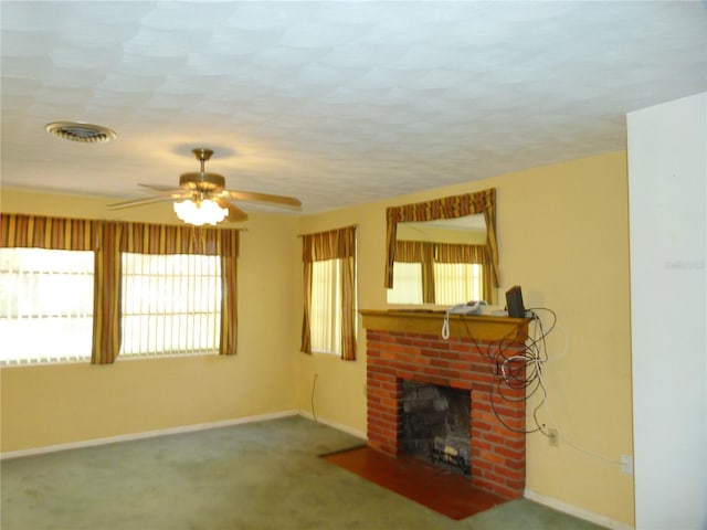 living room with a brick fireplace, carpet flooring, and ceiling fan