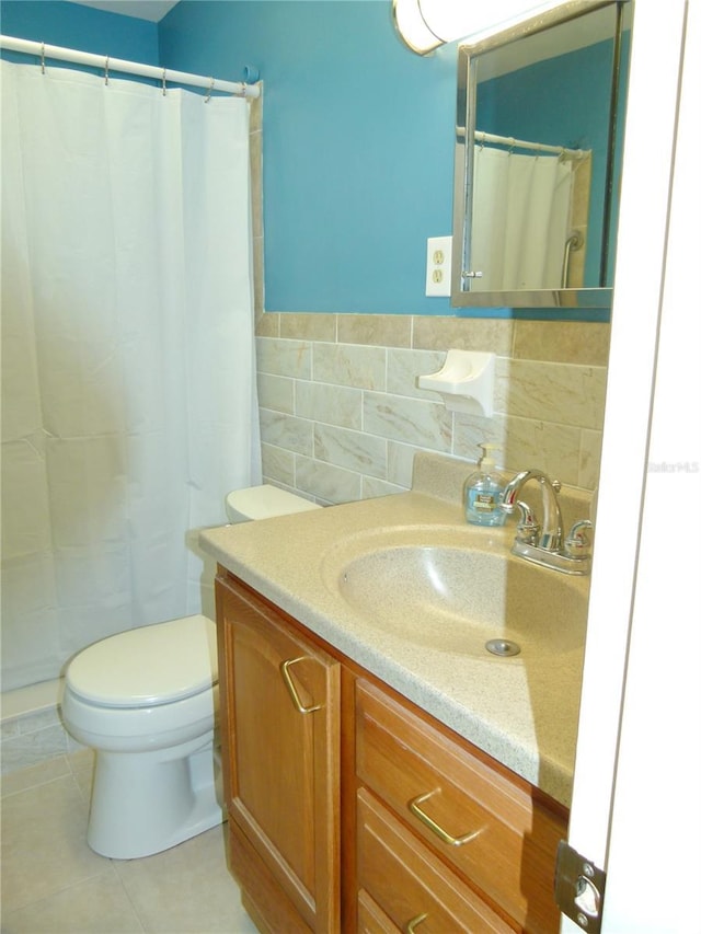 bathroom featuring tile patterned flooring, vanity, tile walls, and toilet