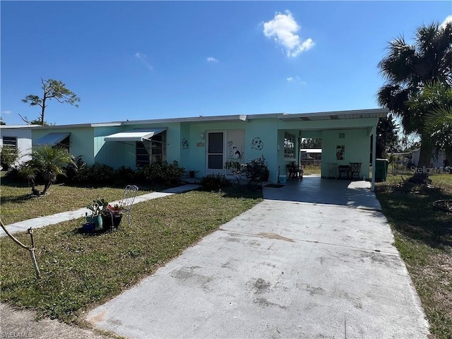 single story home with a front yard and a carport