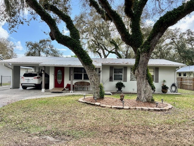 single story home featuring a front lawn and a carport