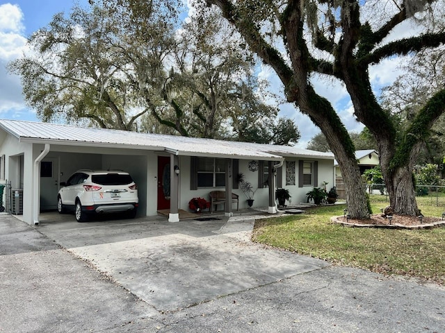 ranch-style home with a front lawn and a carport