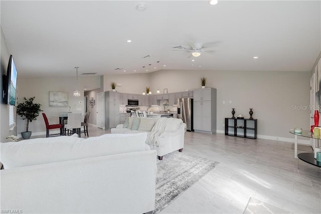 living room featuring vaulted ceiling, ceiling fan, recessed lighting, and baseboards