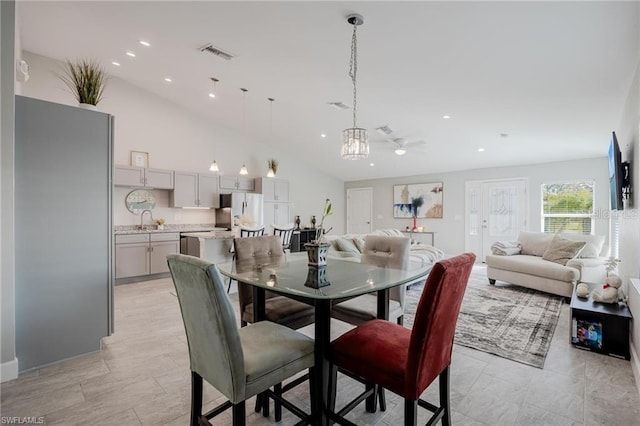 dining space featuring high vaulted ceiling, recessed lighting, and visible vents