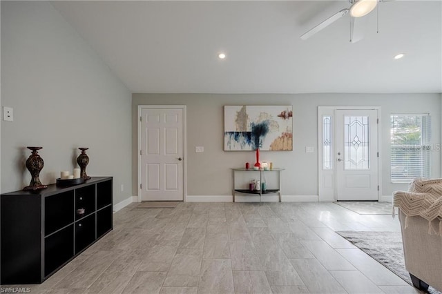 foyer entrance with lofted ceiling, ceiling fan, baseboards, and recessed lighting