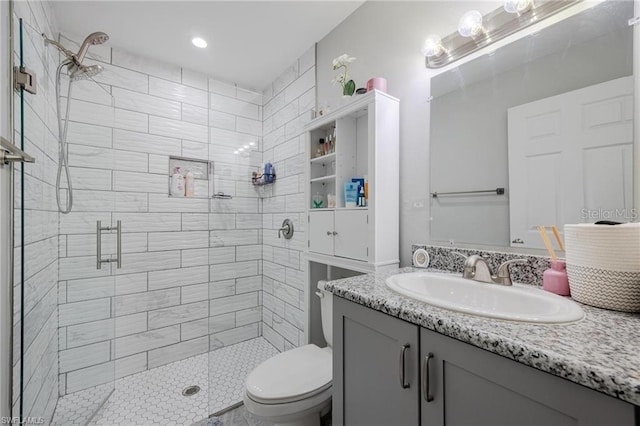 bathroom featuring a stall shower, vanity, and toilet