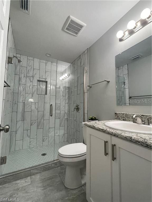 full bath featuring a stall shower, visible vents, vanity, and toilet