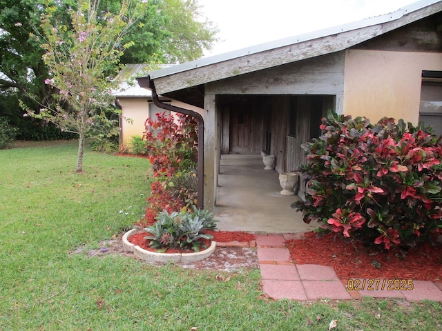 exterior space featuring a yard and stucco siding