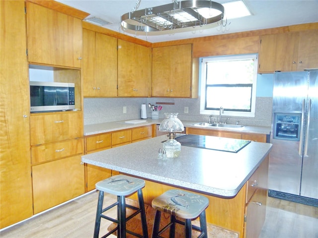 kitchen featuring light countertops, appliances with stainless steel finishes, and a sink