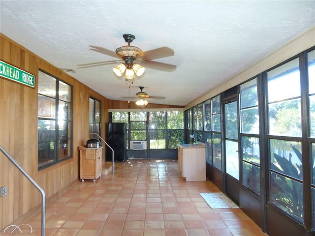 unfurnished sunroom featuring cooling unit and visible vents