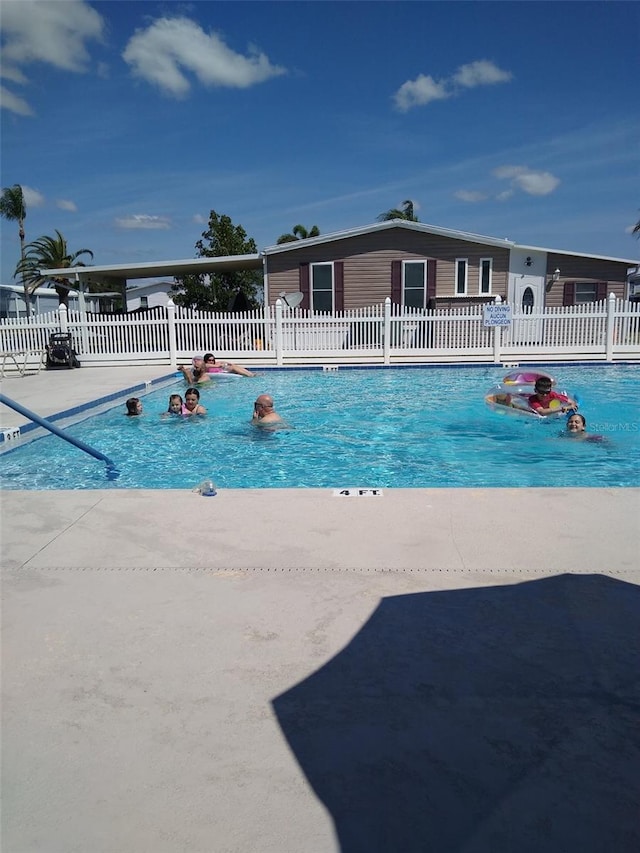 view of pool featuring fence