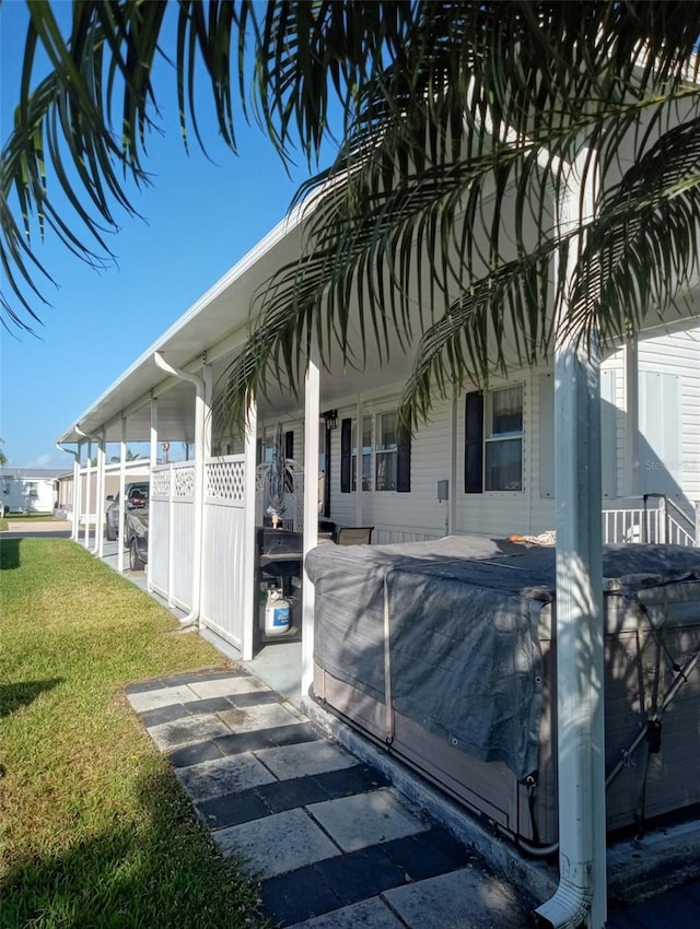 exterior space with covered porch and a yard