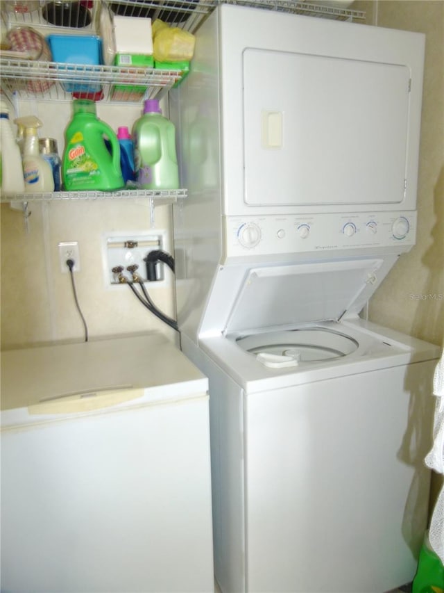 washroom featuring laundry area and stacked washer / drying machine